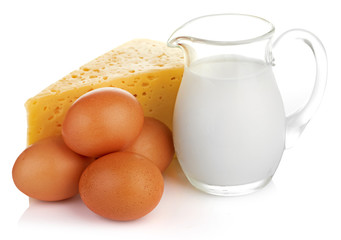 Big piece of cheese, glass jug with milk