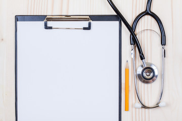 Doctor's stethoscope, clipboard with paper blank, pencil