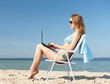 © Syda Productions - girl looking at tablet pc on the beach