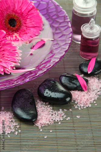 Naklejka na szybę Gerbera flowers on water and spa stones on bamboo mat