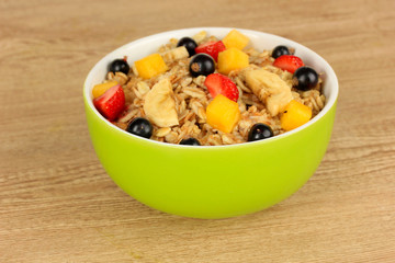 Canvas Print - Oatmeal with fruits on table close-up