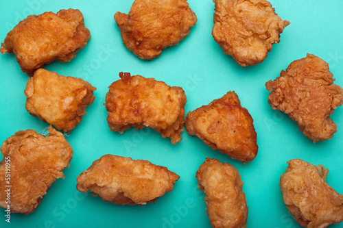Boneless chicken wings on teal surface - Buy this stock ...