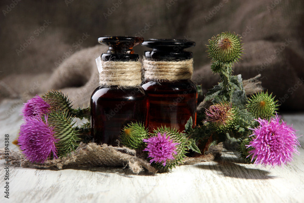 Medicine bottles with thistle flowers