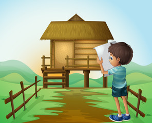 Sticker - A boy with a paper in front of the nipa hut