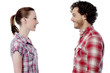 © stockyimages - Casual young couple facing each other