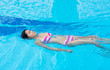 © 9'63 Creation - An Asian girl is swimming backstroke in the swimming pool