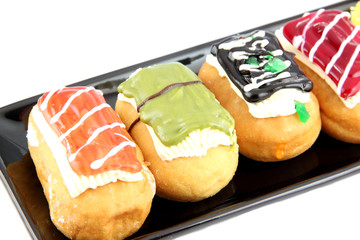 Wall Mural - Sushi Donuts in the black dish on white background.