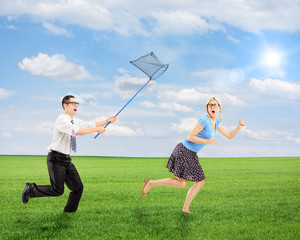 Wall Mural - Scared young female trying to runaway from man running with butt