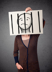 Wall Mural - Woman holding a paper with a prisoner behind the bars on it in f