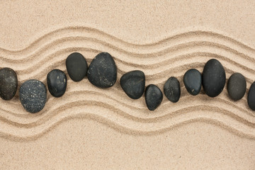 Wall Mural - Black stones on the sand