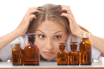 Wall Mural - woman doctor with medication in glass bottles