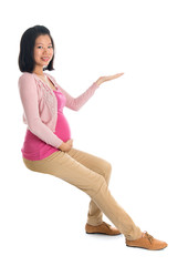 Poster - Pregnant Asian woman hand showing empty space