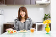 © taka - beautiful asian woman eating in the kitchen