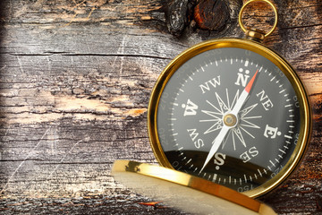 Wall Mural - Compass on cracked wooden background