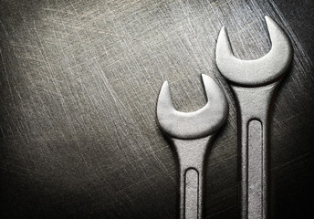 Spanner on steel scratchy background