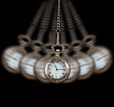 Fototapeta Konie - Pocket watch swinging on a chain black background