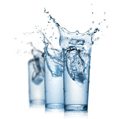 Wall Mural - water splash in glasses isolated on white