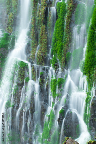 Naklejka ścienna Detail of a waterfall with blurred motion