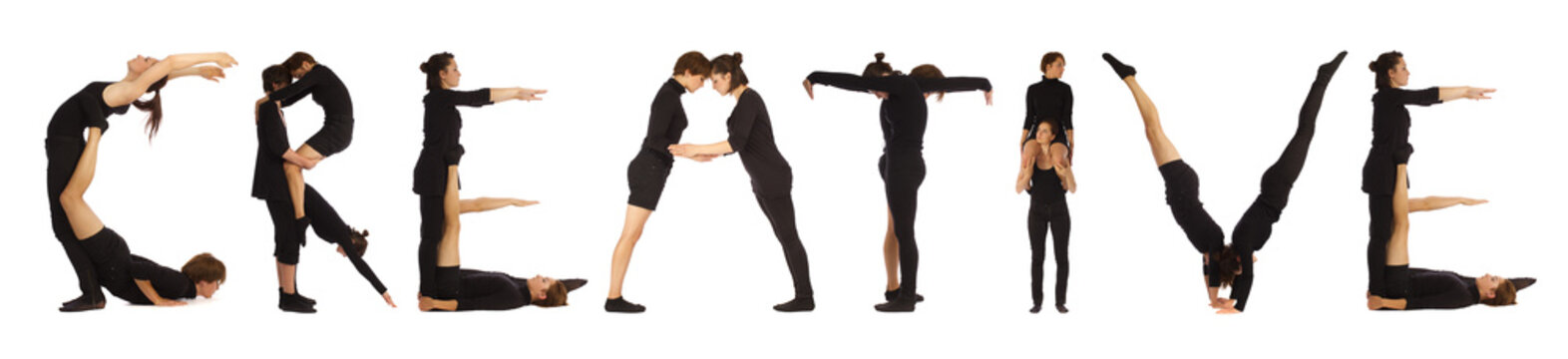 Group of black dressed people standing forming CREATIVE word