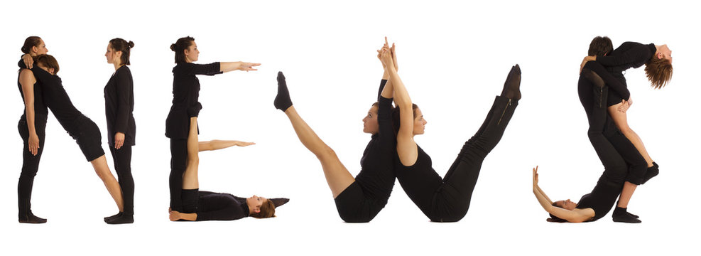 people standing over white forming NEWS word