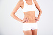 © Africa Studio - Beautiful woman stomach on  gray background