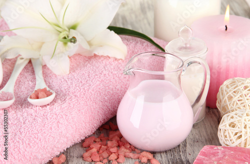 Naklejka na kafelki Beautiful spa setting with lily on wooden table close-up