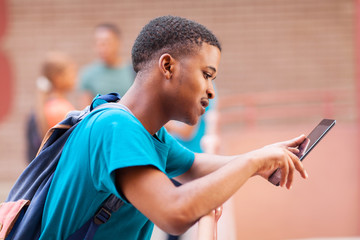 Wall Mural - male african college student using tablet computer