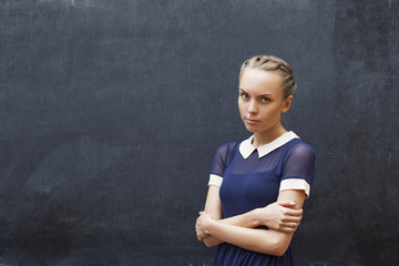 Beautiful female student near a school board