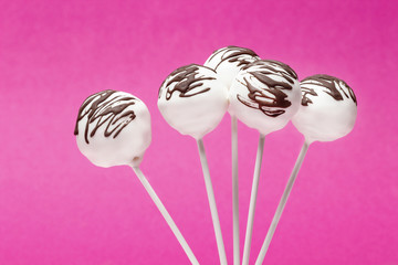 Poster - Chocolate cake pops on pink background