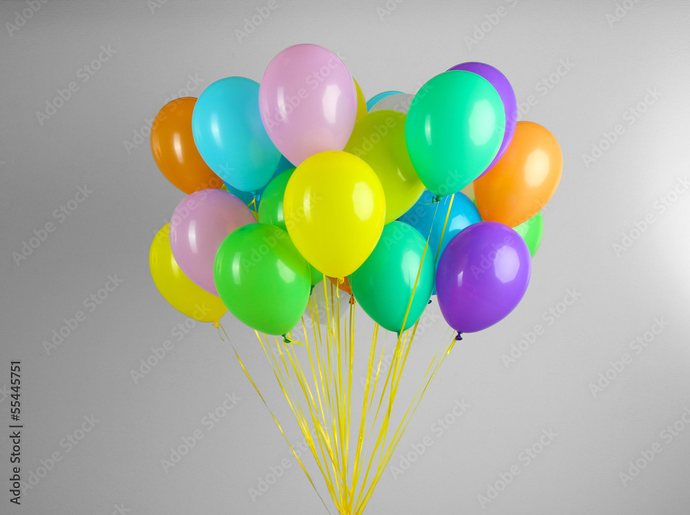 Colorful balloons on grey background