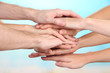 © Africa Studio - United hands on bright background. Conceptual photo of teamwork