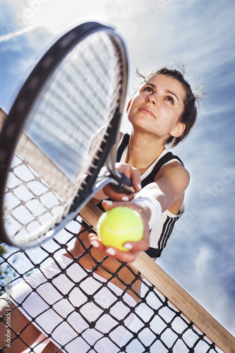 Beautiful young girl rests on a tennis net Poster