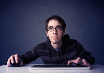 Fototapete - Hacker working with keyboard on blue background