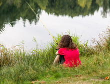 Young Girl Waiting For Fish To Bite