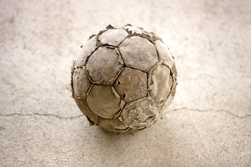 Old used football on asphalt