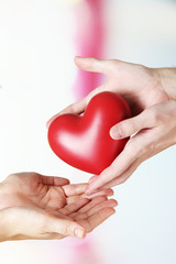 Poster - Heart in hands on light background