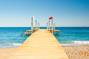 empty wooden pier stretching into the sea, shot at dawn