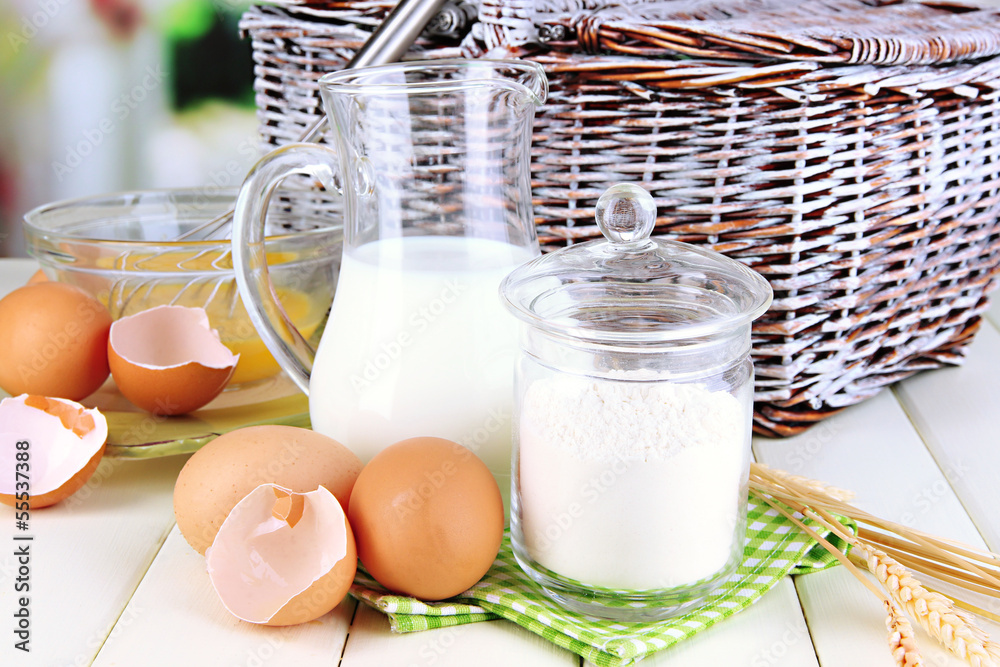 Ingredients for dough on wooden table on natural background