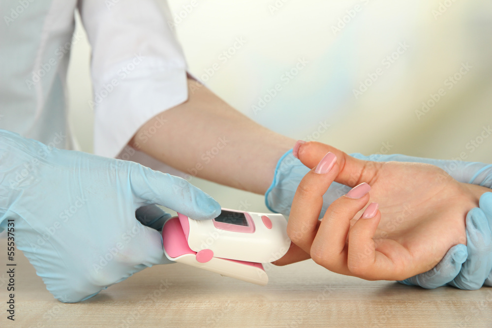 Doctor measuring pulse rate and oxygen levels, Stock Photo | Adobe Stock