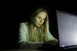 © grufnar - blonde woman working on a computer by night