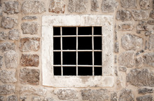 Ancient Stone Prison Wall With Metal Window Bars