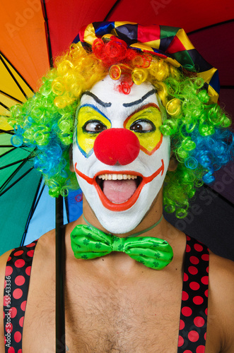 Fototapeta na wymiar Clown with umbrella isolated on white