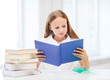 © Syda Productions - girl studying and reading book at school