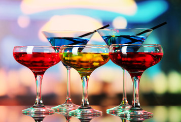 Poster - Glasses of cocktails on bright background