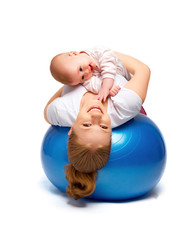 Wall Mural - mother and baby doing gymnastic exercises on the ball