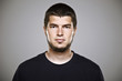 © bonninturina - Portrait of a real man over grey background.
