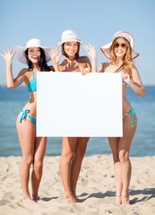 Poster - girls with blank board on the beach