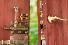 Metal Bolts, Latches And Hooks In Wooden Open Door Close-up
