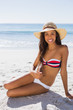 © WavebreakmediaMicro - Sexy young tanned woman wearing straw hat posing