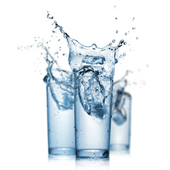 Wall Mural - water splash in glasses isolated on white